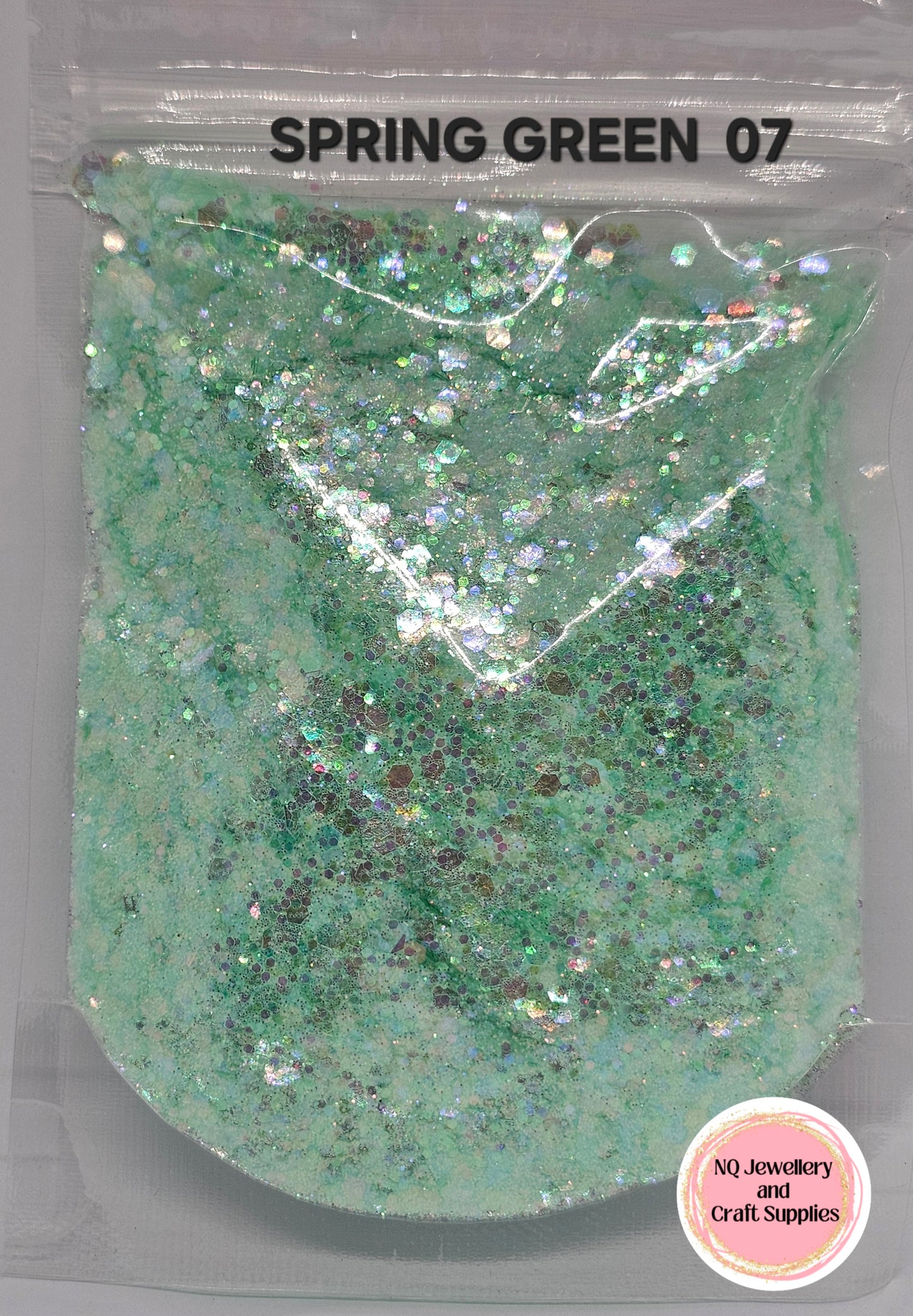 Green glittery powder in a clear packaging labeled 'Spring Green 07' with NQ Jewellery and Craft Supplies branding.