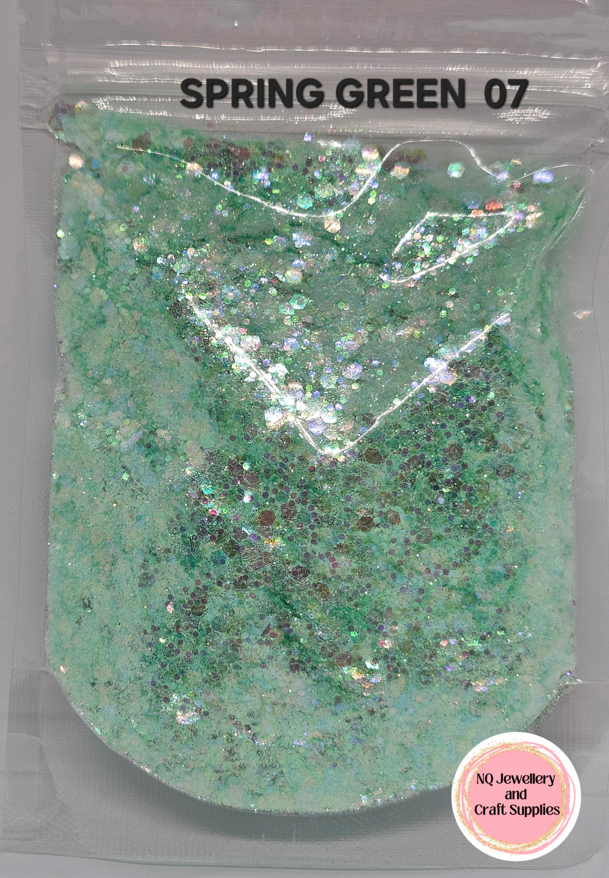 Green glittery powder in a clear packaging labeled 'Spring Green 07' with NQ Jewellery and Craft Supplies branding.