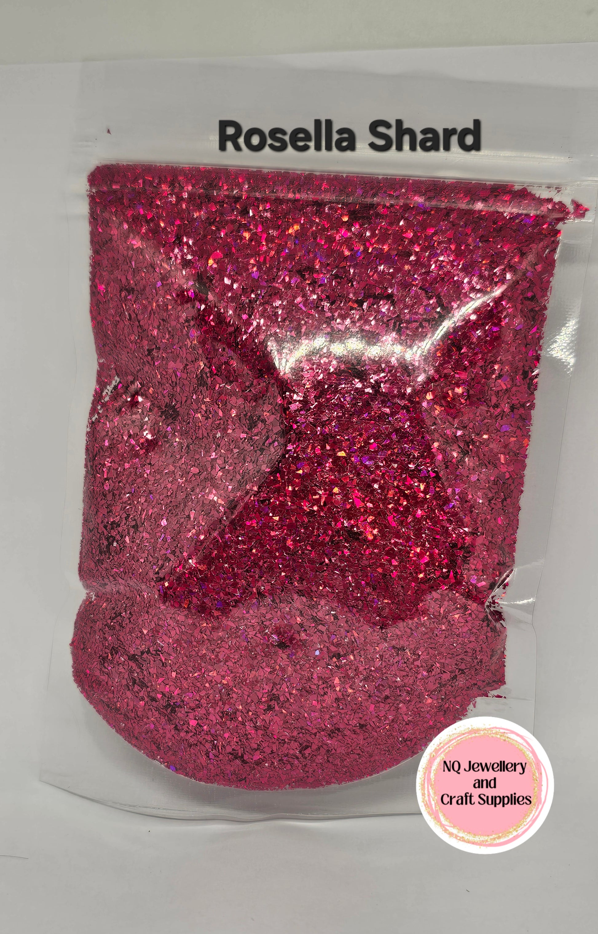 Pink glittery material in a clear package with 'Rosella Shard' branding.